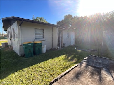 Back of property with concrete block siding and a