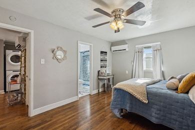 Bedroom with a wall mounted air conditioner, wood 
