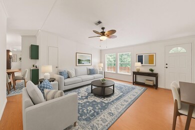 Living area with light wood-type flooring, a ceil
