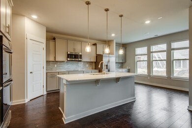 Huge kitchen with island, pendant lights, double oven, huge pantry and lots of kitchen cabinets