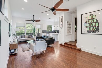 Living room with a ceiling fan, wood finished flo