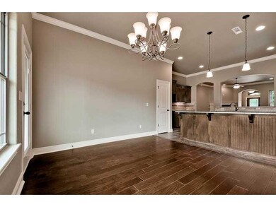 Exterior Front. Dining area with wood flooring and granite bar