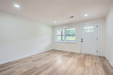 Entrance foyer featuring visible vents, baseboards