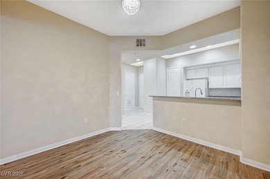 Unfurnished room featuring recessed lighting, visible vents, light wood-style flooring, and baseboards