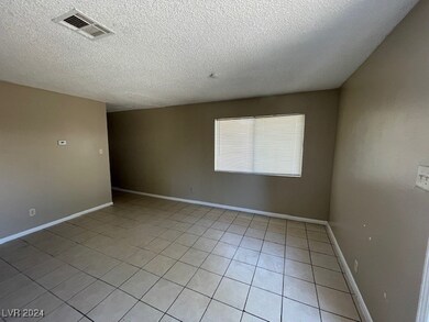 Apt 1's  Spacious Living Room w/ Tile Flooring & T