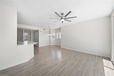Unfurnished living room featuring ceiling fan and 