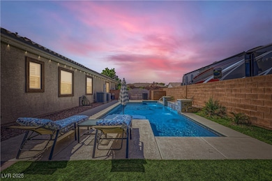 Pool at dusk with a fenced backyard, cooling unit,