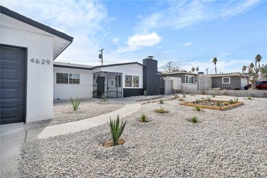 View of front of house with a garden and stucco si
