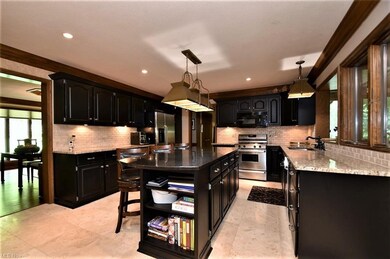 Sleekly updated cabinetry and travertine tile flooring take the Kitchen to a whole new fresh look.  The incredible island is chic and clean for preparing delicious dinners and creating the core for entertaining.