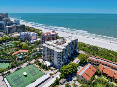 Bird's eye view of apartment complex and extended coastline