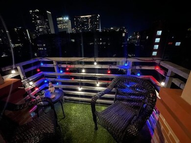Balcony at twilight featuring a view of city ligh