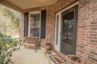 Charming entrance on this home with a spacious cov