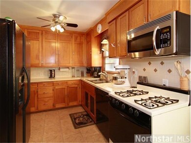 The kitchen boasts ceramic tiled floors and custom