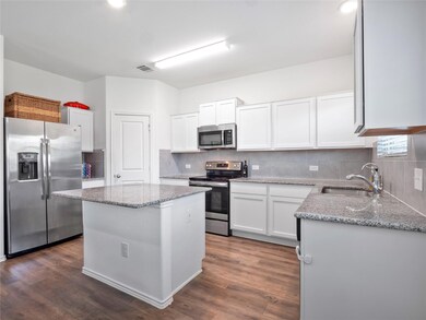 Kitchen featuring appliances with stainless steel