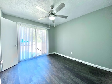 Empty room with baseboards, a textured ceiling, ce