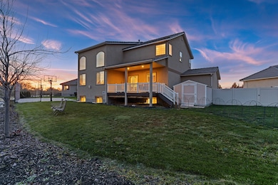 Back of property featuring a fenced backyard, stucco siding, and a wooden deck