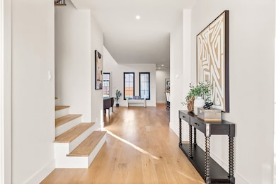 Foyer entrance featuring light wood-style flooring and recessed lighting