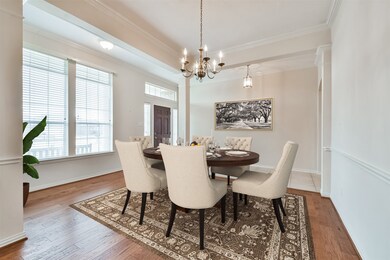 Formal dining room with rich hardwood. Virtually staged flooring and custom millwork