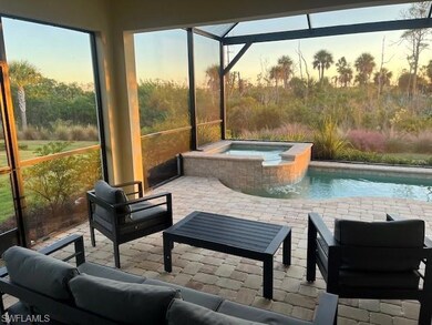 View of swimming pool with a lanai, an outdoor living space, a patio, a sunroom, and a pool with connected hot tub