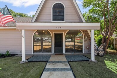 Property entrance featuring a yard and a shingled roof