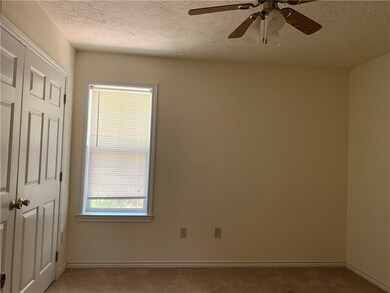 Spare room with light carpet, baseboards, a textur