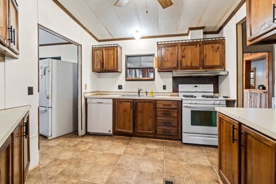 Another view of the kitchen with additional cabinets and counter on the left and right.