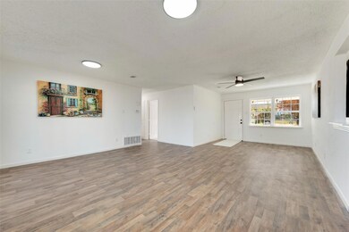 Unfurnished living room with ceiling fan, wood-typ