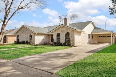 Elegant front view with new sod, lush landscaping,