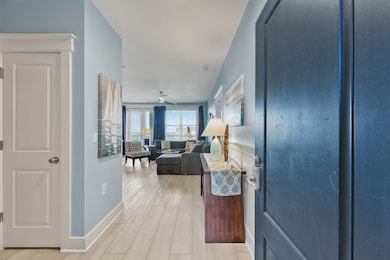 The inviting entry sets the tone with soothing coastal décor and durable vinyl plank flooring, creating a seamless flow into the main living spaces.