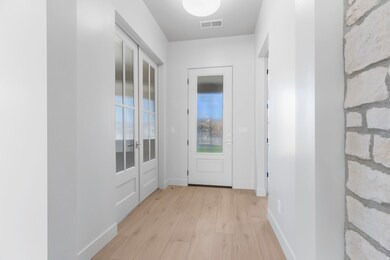 Doorway to outside with wood finished floors and baseboards