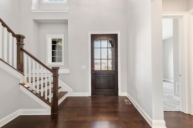 Grand 2 story foyer with beautiful hardwood and trim detail!