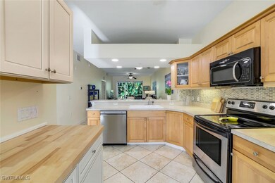 Kitchen with decorative backsplash, appliances wit
