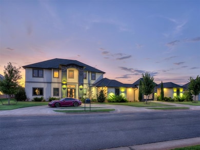 View of front facade with curved driveway, stucco siding, and a front yard