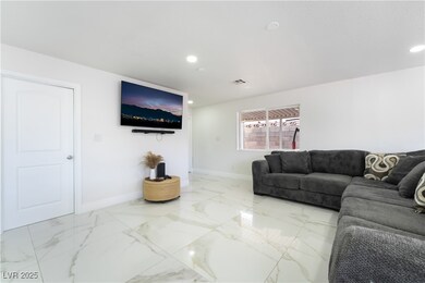 Living area with baseboards and recessed lighting
