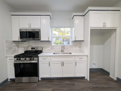 Brand new all white kitchen with gas stove, refrig
