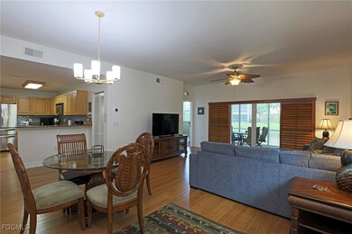 Dining room featuring a chandelier, light wood finished floors, and a ceiling fan