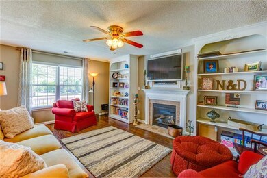 Great room features fireplace, built-in bookshelve