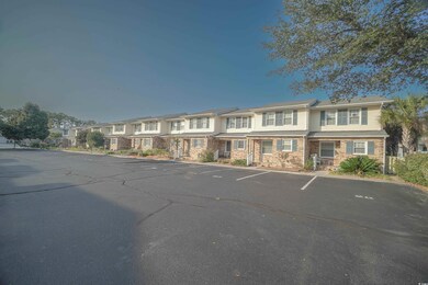 View of property with a residential view and uncovered parking