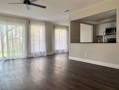 Unfurnished living room featuring dark wood-style