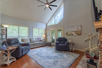 Living area with high vaulted ceiling, a ceiling f