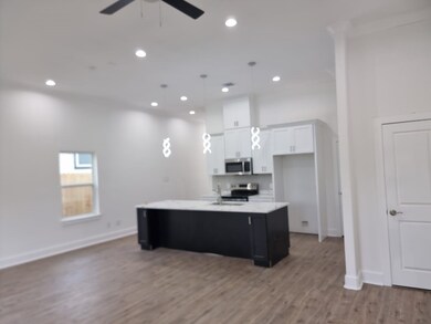 Modern open-concept kitchen with high ceilings, re