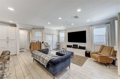 Living area with ornamental molding, visible vents
