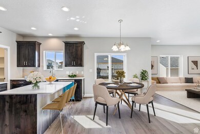 Dining space featuring light wood-style floors, recessed lighting, a chandelier, and a textured ceiling