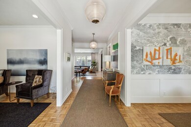 Hallway featuring wainscoting, baseboards, and cro
