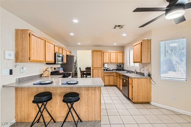 Kitchen with light countertops, a breakfast bar ar