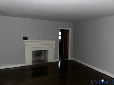 Unfurnished living room featuring dark wood-style floors and a fireplace