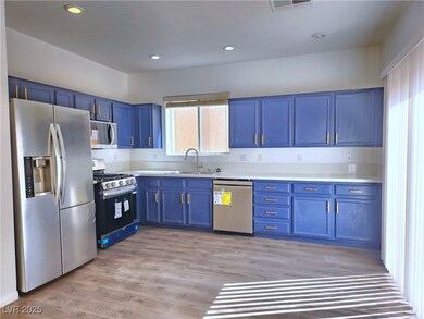 Kitchen with light wood-style floors, appliances w
