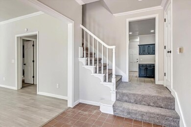 Stairs featuring ornamental molding and tile patterned floors