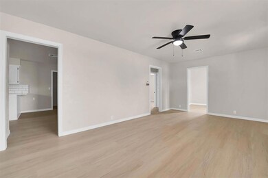 living room featuring light wood-type flooring and ceiling fan