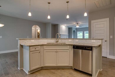 Large granite topped island provides plenty of counter space
